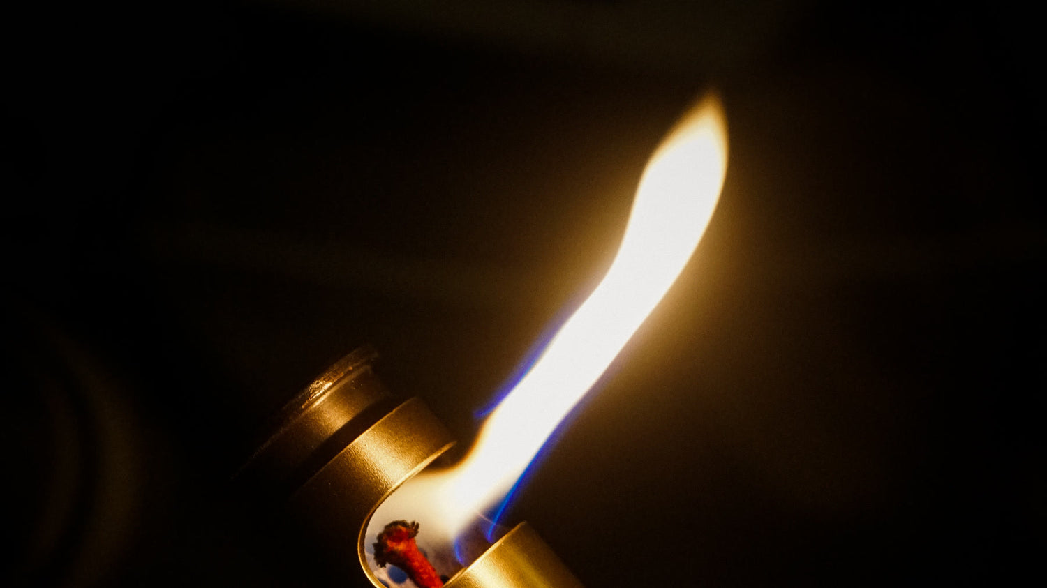 Real flint lighter producing a spark and flame during a controlled ignition check