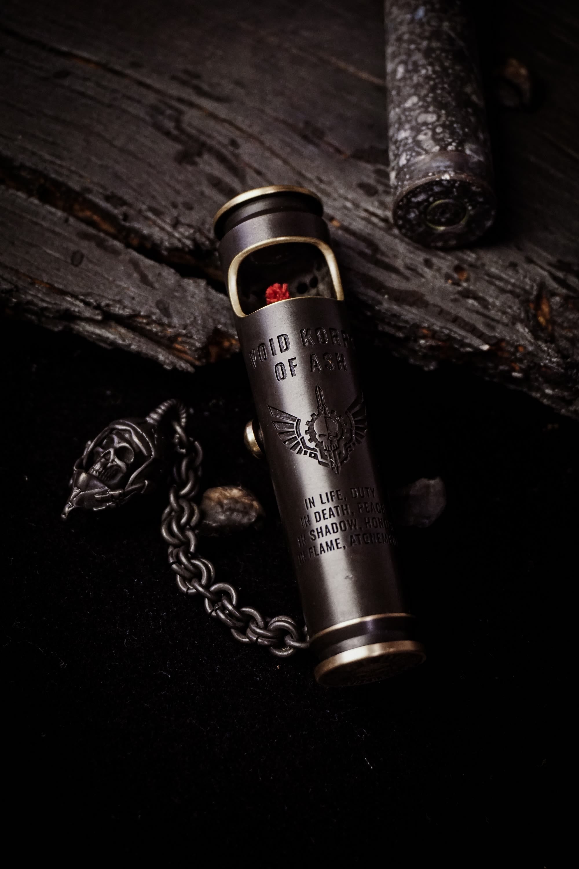 Open Large Void Korps skull lighter showing the wick, engraving, and pirate chain charm