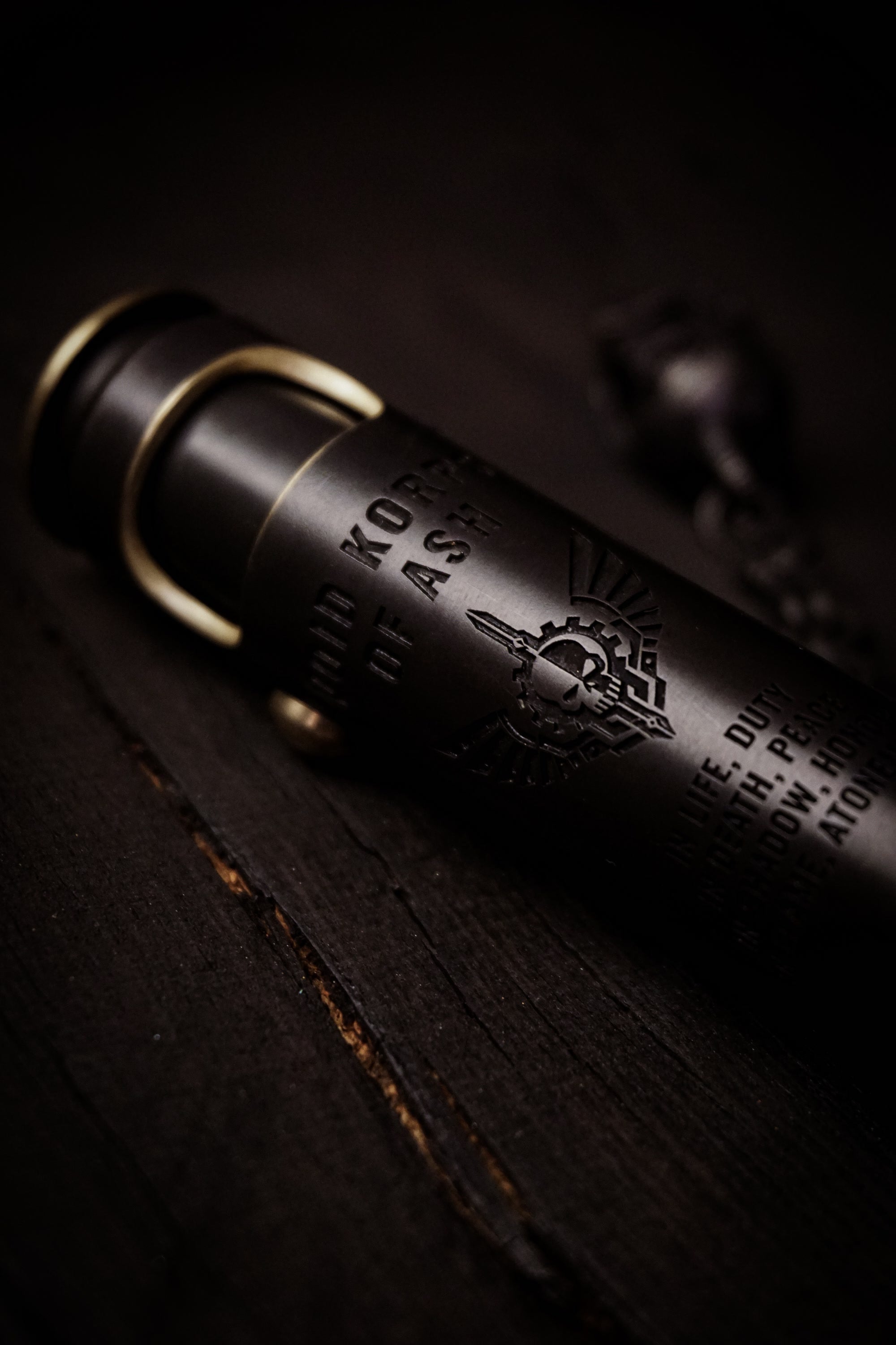 Large Void Korps macro detail of pirate-black finish, lettering, and engraved emblem
