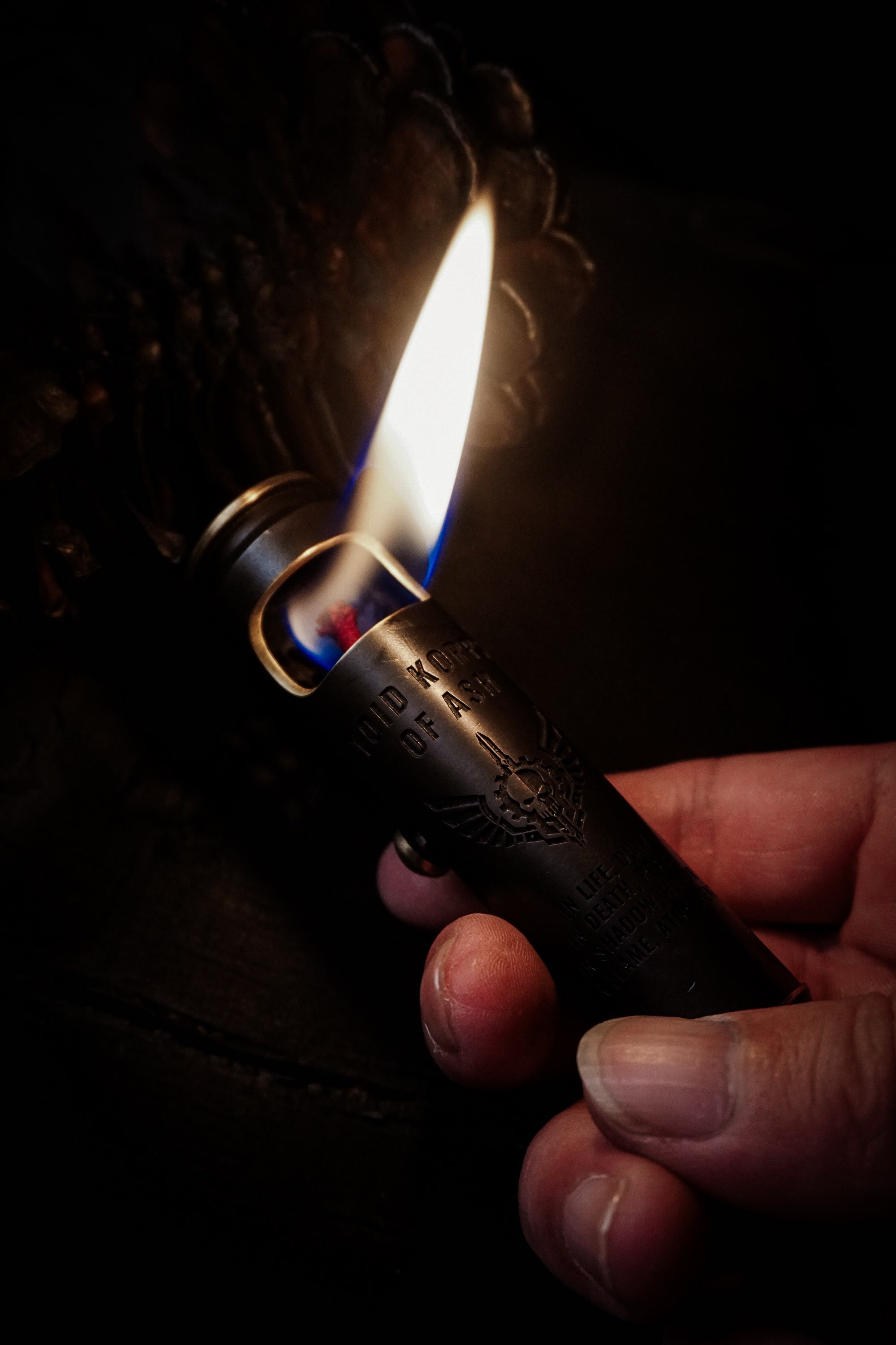 Large Void Korps skull lighter lit and held in one hand for scale