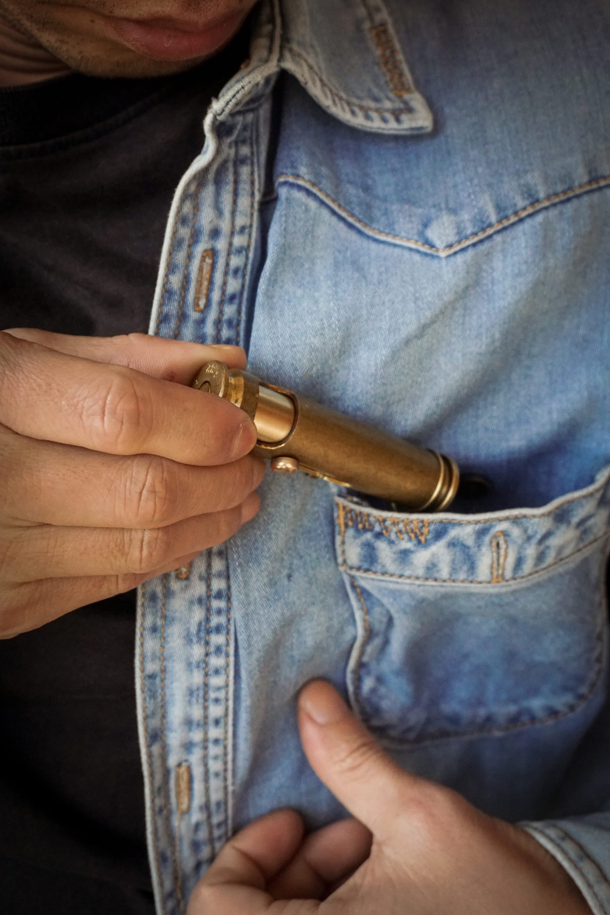 Fancy Lighter is taken out of the pocket of the denim jacket