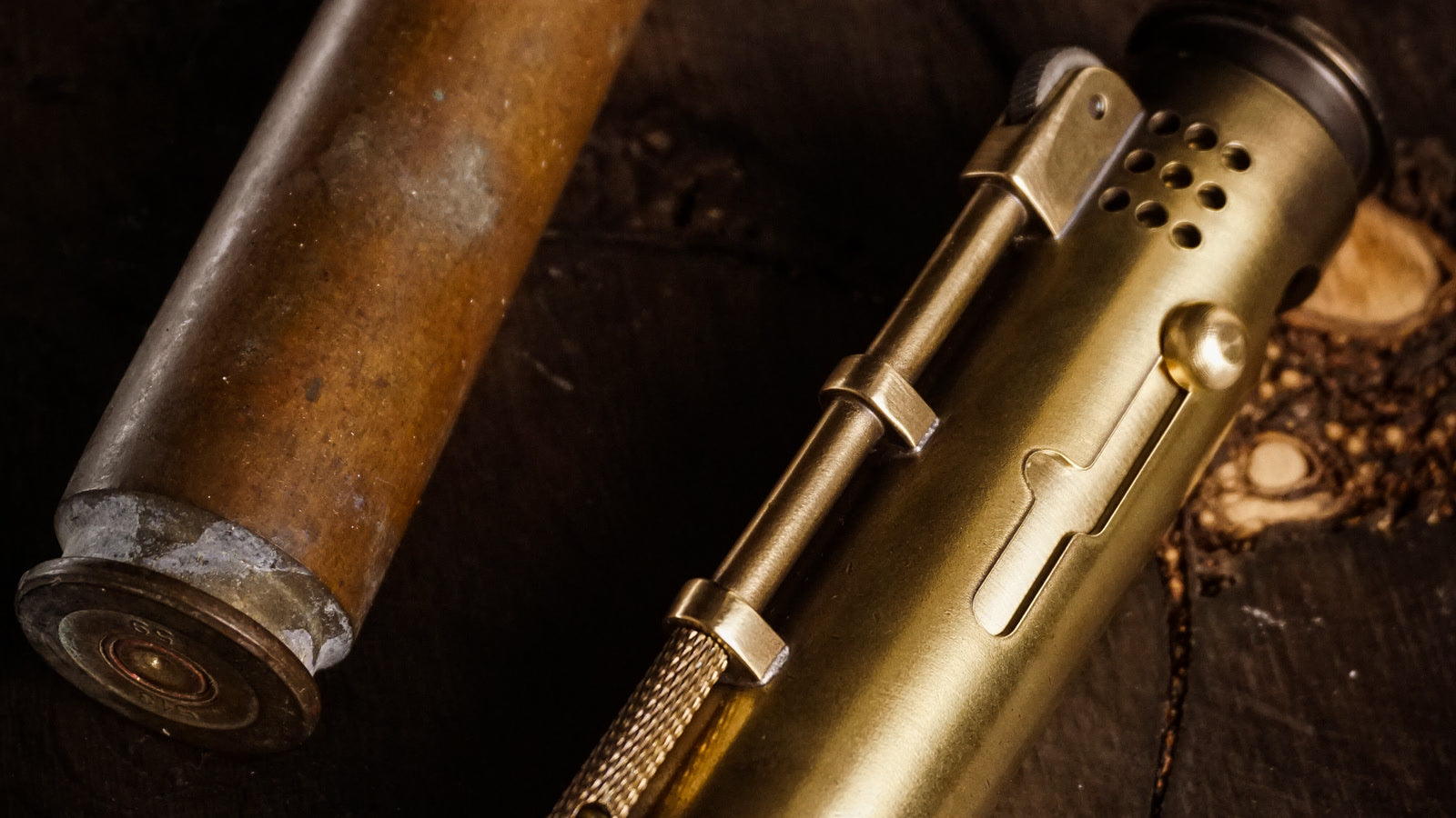 Collector-size brass lighter beside its source casing