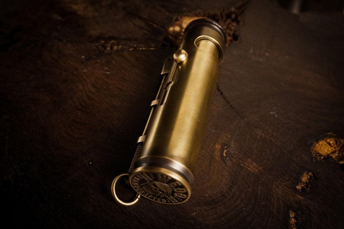 A brass lighter resting diagonally on dark leather
