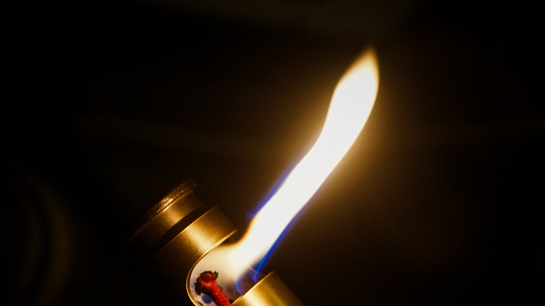 Real flint lighter producing a spark and flame during a controlled ignition check