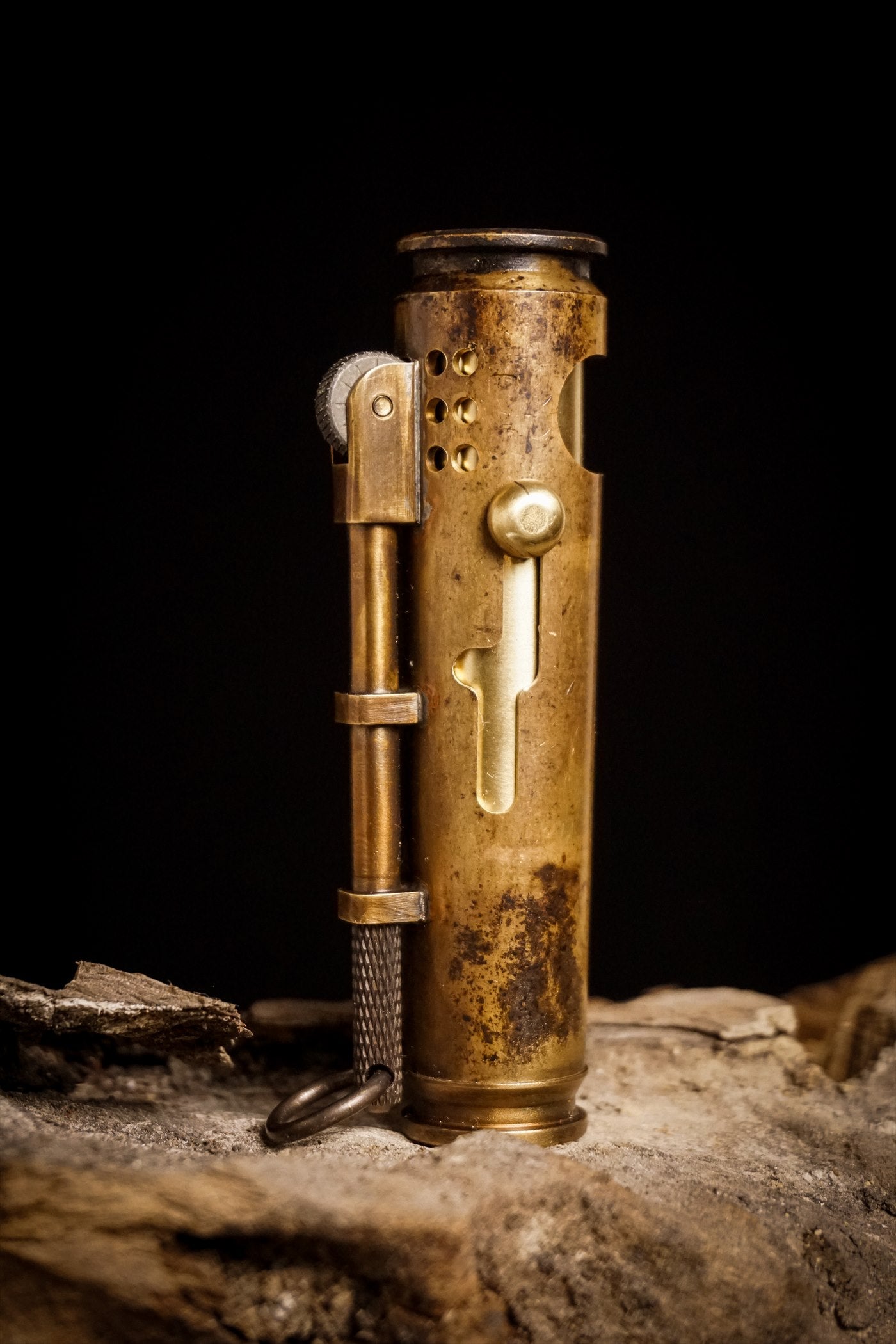 Antique brass military lighter with honest patina, representing the pre-war brass lighter era