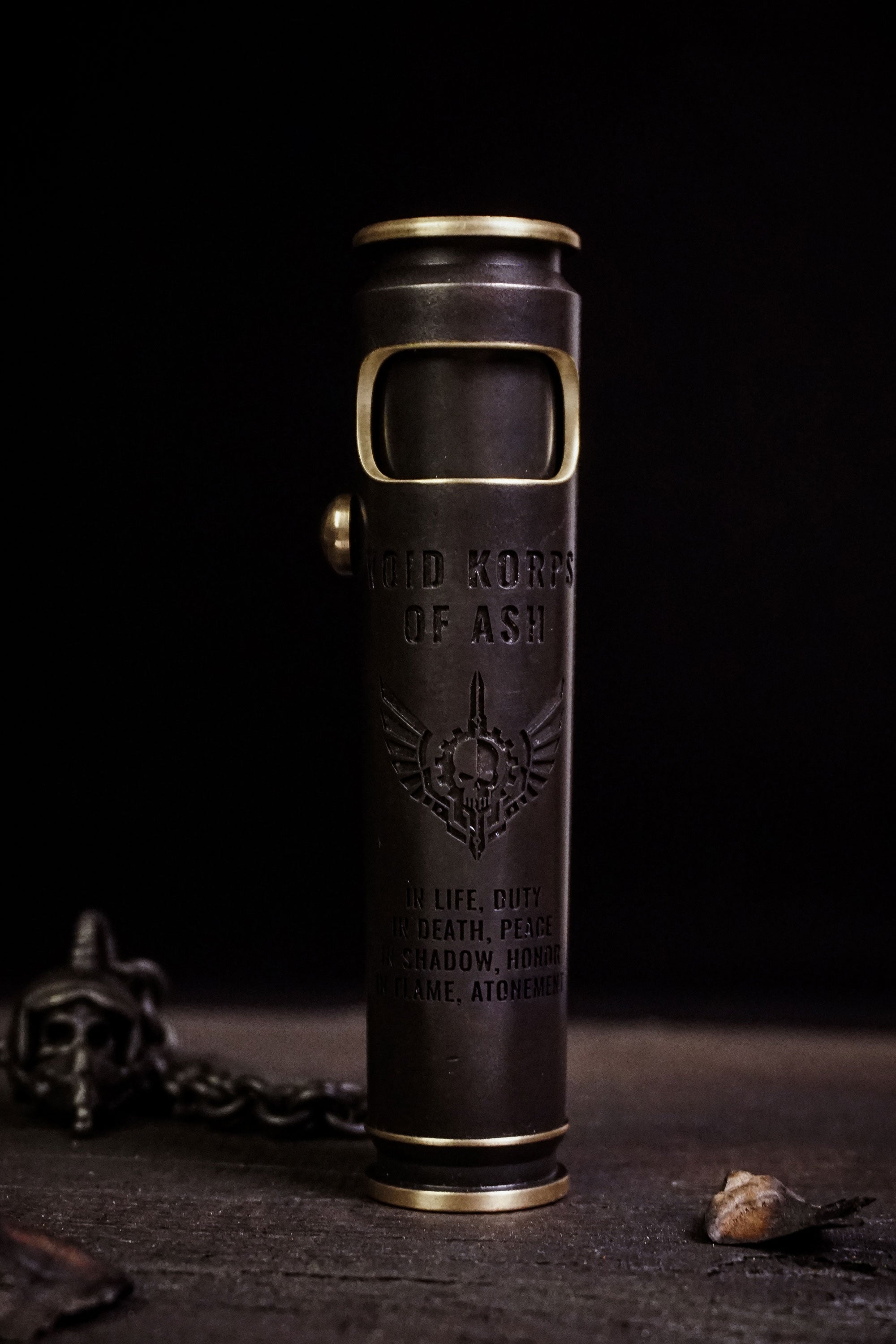 Large Void Korps skull lighter with pirate-black brass finish and engraved front artwork