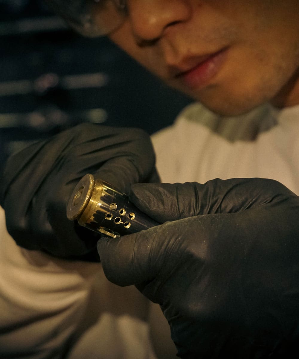 Hand assembly of a WEDO handmade bullet shell lighter in the workshop